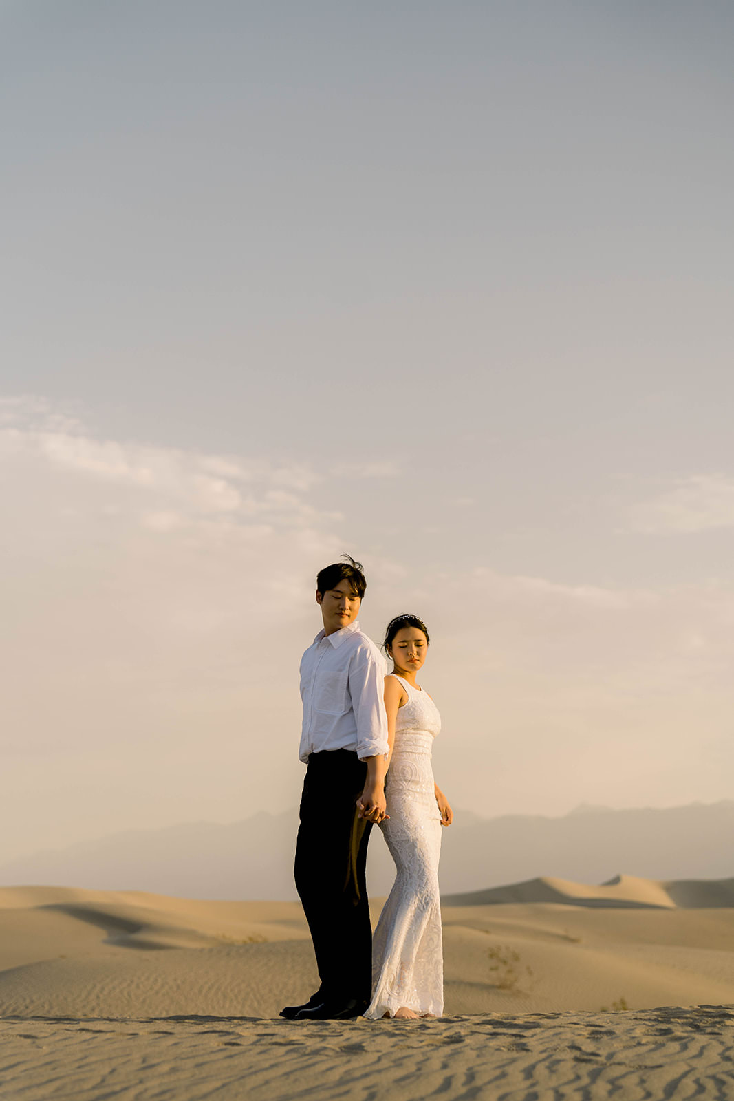 Couple in wedding attire in the desert