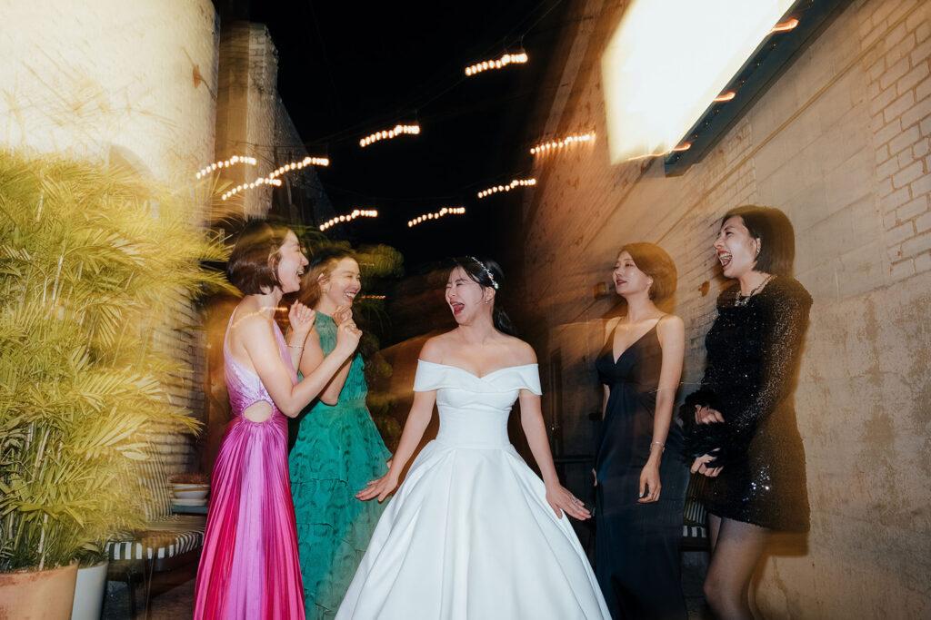 bride with the bridal party in the alleyway at night