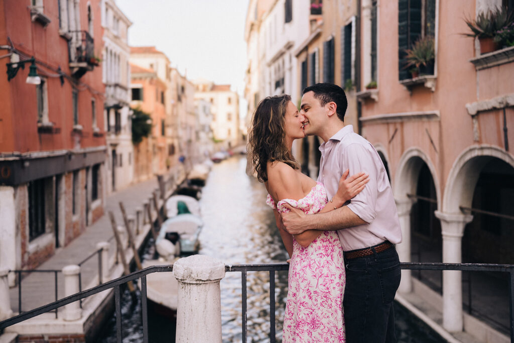 Couple kissing on top of Venice Canals in Venezia, Italy