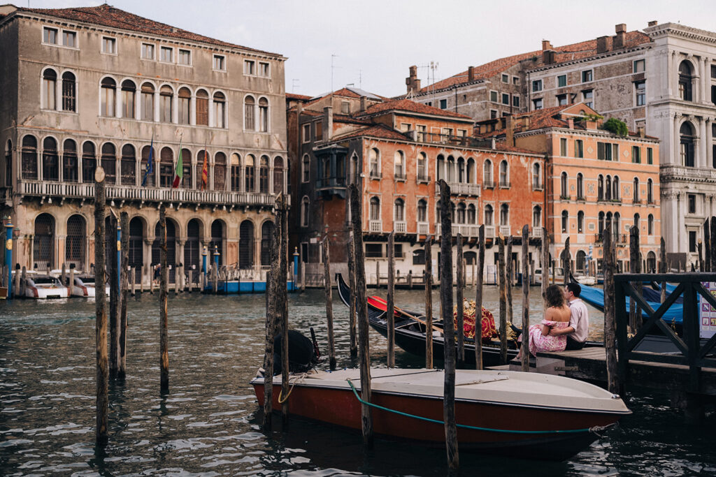 Couple sitting by the gondolas by the Grand Canals in Venezia, Italy. One of the very first city Eugene Kim Photography got to photograph in Europe.