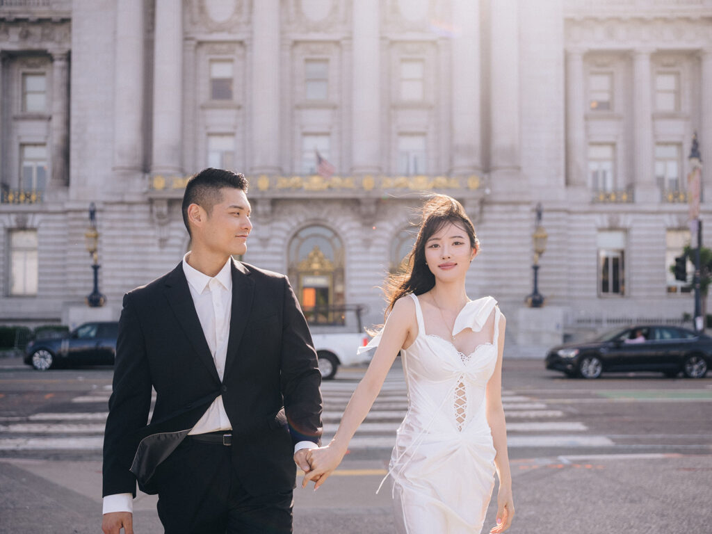 Couple walking in front of the San Francisco City Hall after their wedding. The backlit is pretty. San Francisco is where Eugene Kim Photography is based alongside with Las Vegas.