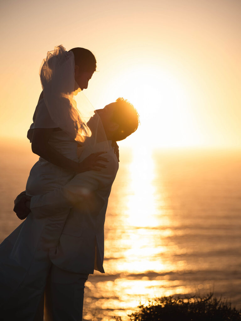 Couple watching the sunset after their malibu eloepment