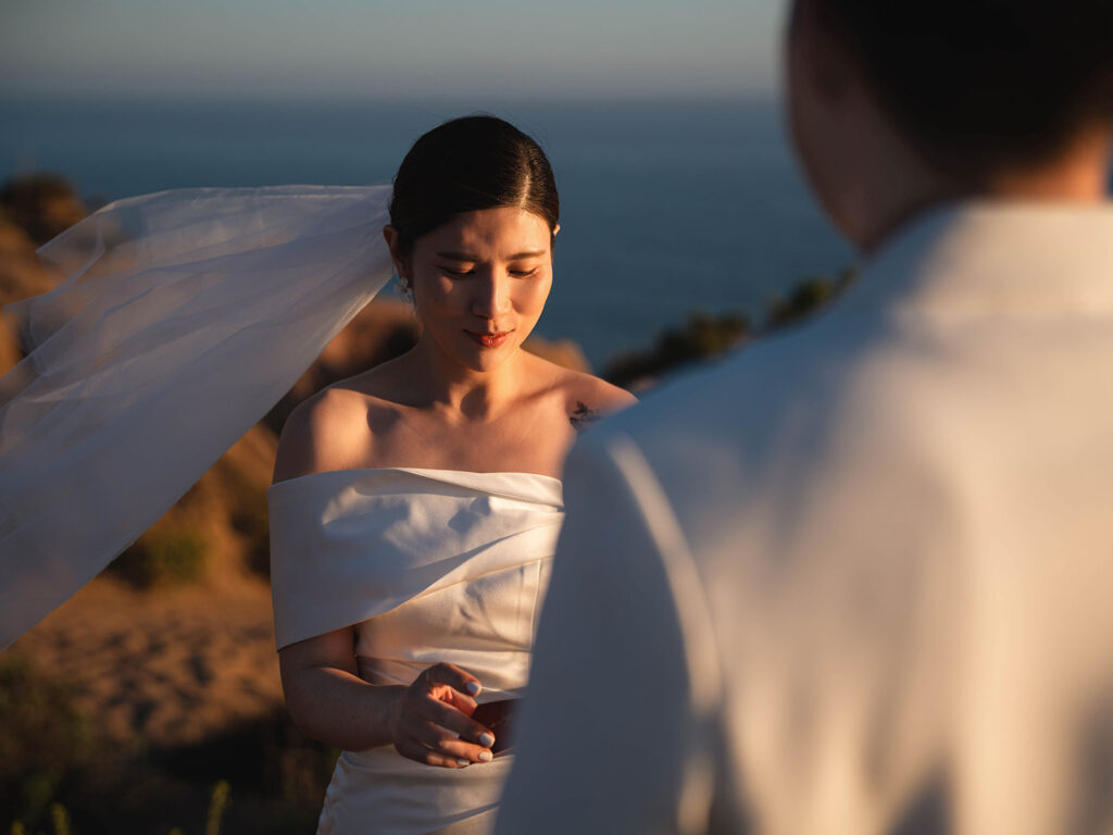 Couple reading vows to each other at their Sunset Malibu Elopement