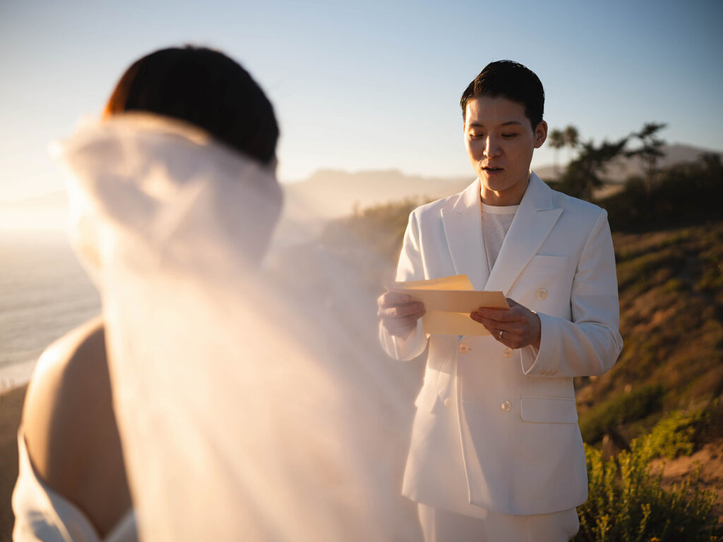 Couple reading vows to each other at their Sunset Malibu Elopement