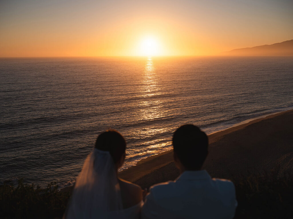 Couple watching the sunset after their malibu eloepment