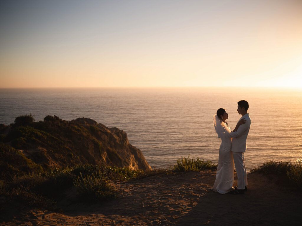 Couple watching the sunset after their malibu eloepment