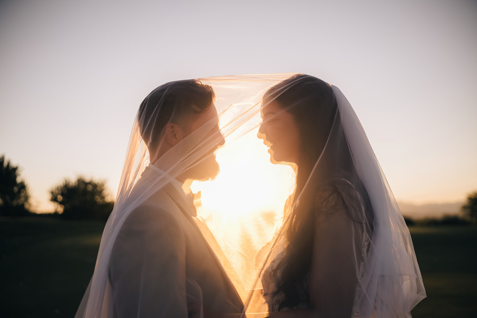 Couple looking into each other at sunset