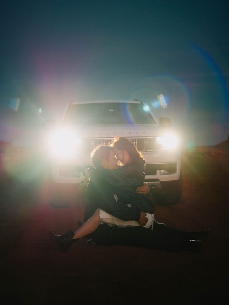 Couple during an adventure engagement session out in Monument Valley, Utah
