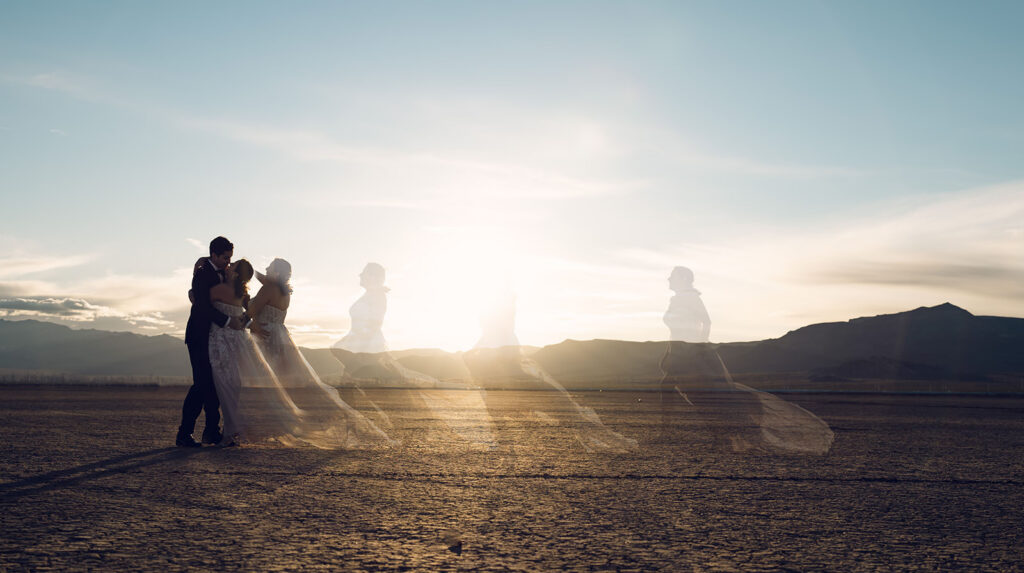 Couple standing on cracked earth at El Dorado dry lake bed during a Las Vegas wedding photographer session