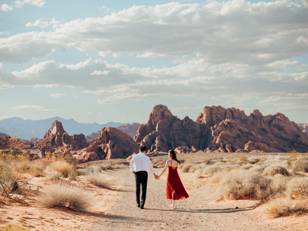 Couple walking hand in hand through the red rocks of Valley of Fire near Las Vegas