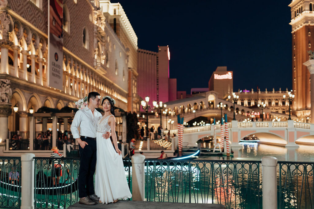 Couple at blue hour on the Las Vegas Strip with neon reflections behind them