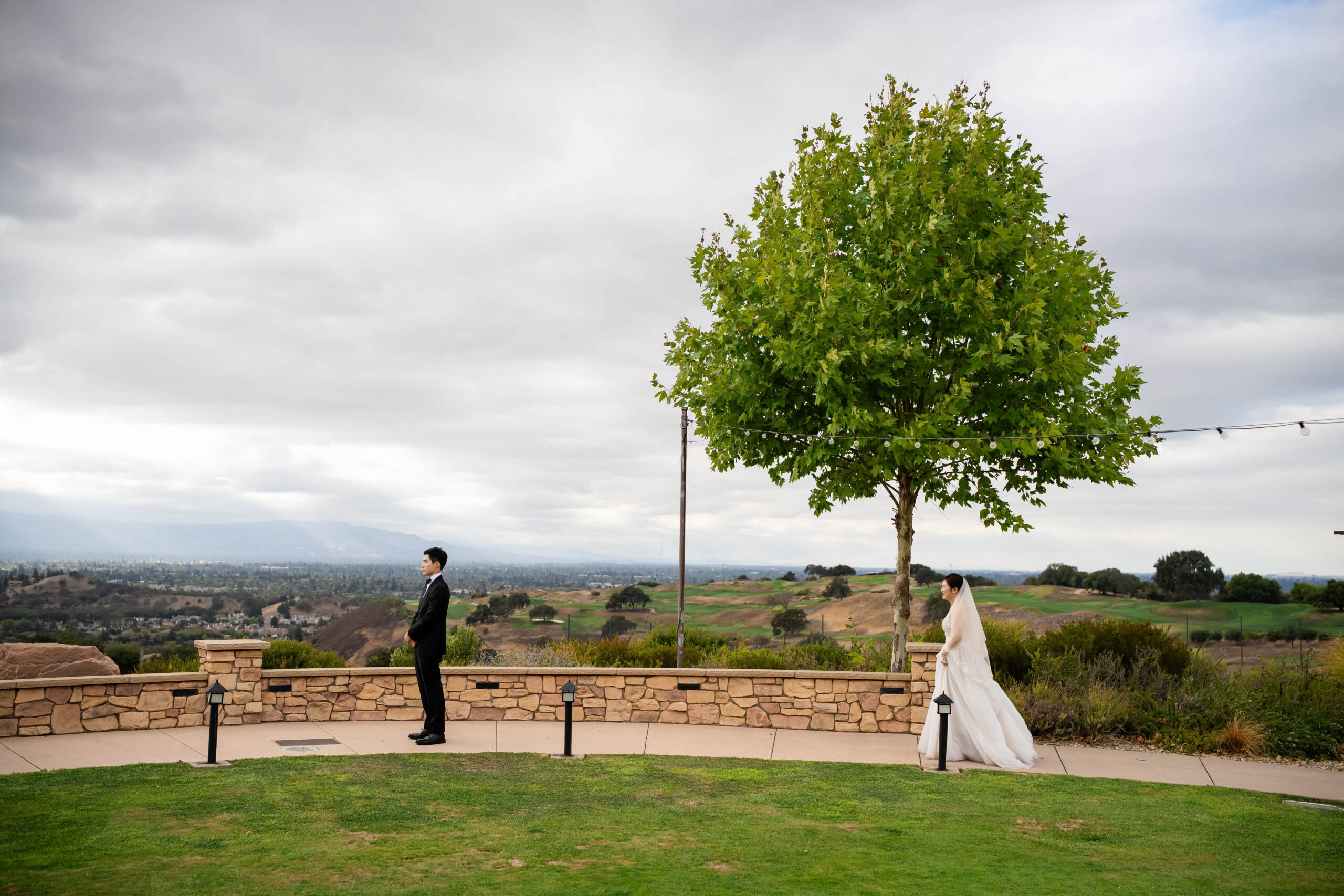 Bride approaching the groom for their first look on the terrace at Boulder Ridge Golf Club.